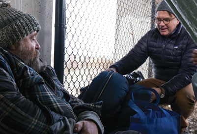Man helping a homeless Man